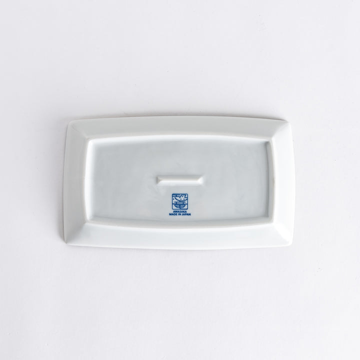 Bottom view of the rectangular dessert plate, displaying the manufacturer’s mark and smooth surface.