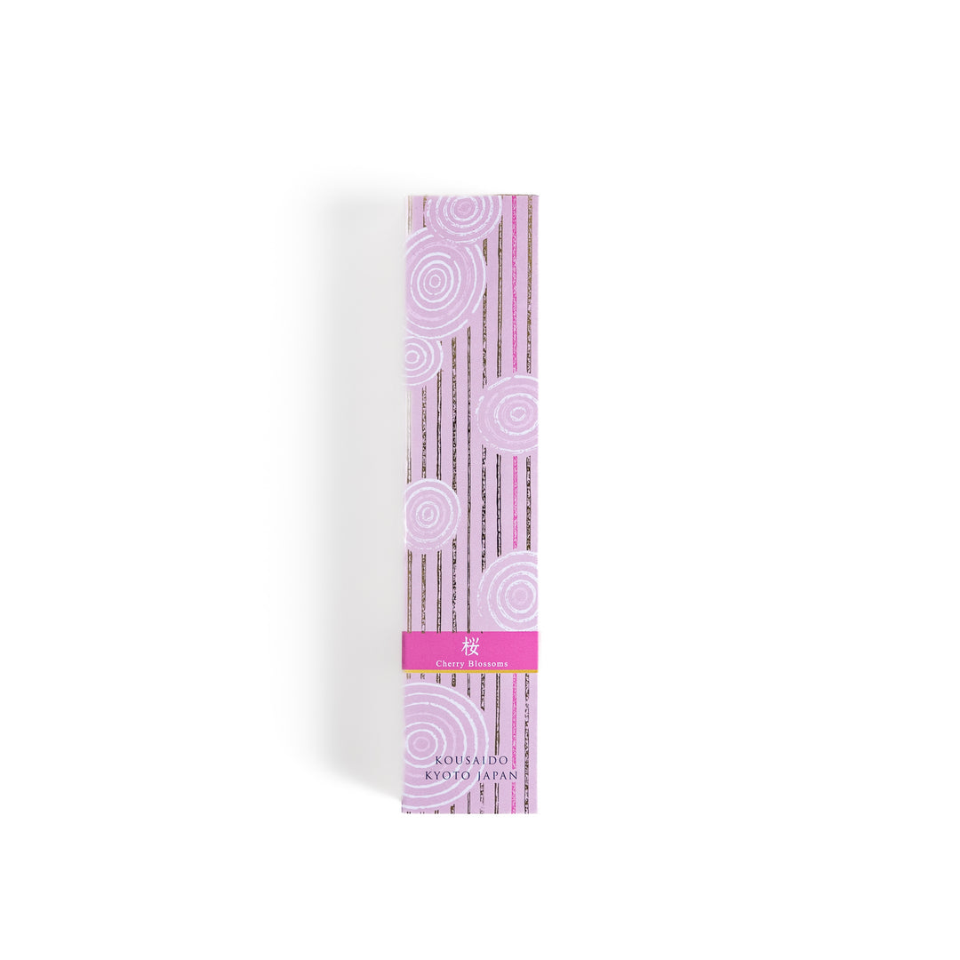 Elegant Sakura Incense in a light wooden box with soft pink sticks, elegantly packaged in a delicate pink design featuring white circular patterns, evoking the gentle aroma of cherry blossoms.