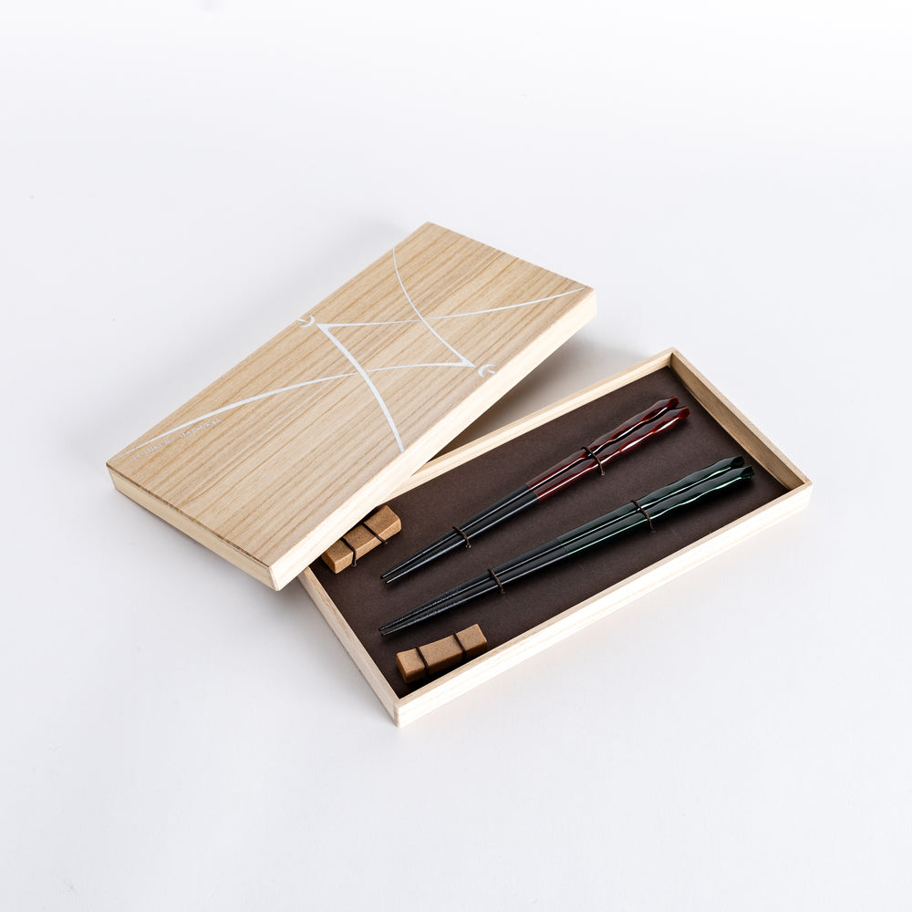 Ember and Forest Carved Chopsticks Set placed in a beautiful wooden box, showcasing the intricate designs and elegant presentation.