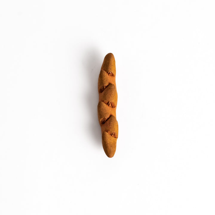 Epi Bread Chopstick Rest shaped like a baguette with intricate details and a warm brown finish, perfect for adding charm to your table setting.