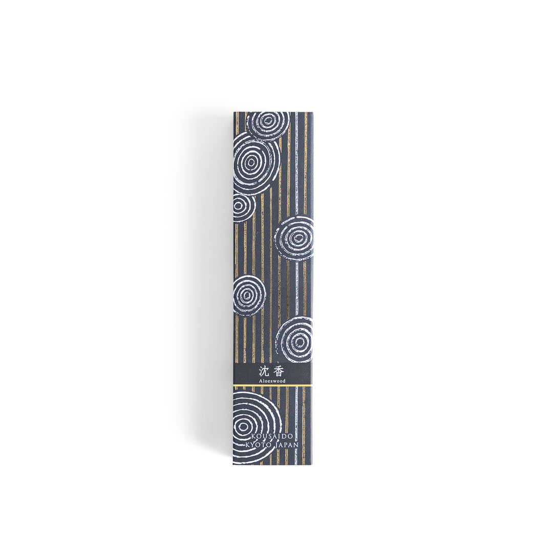 Ethereal Agarwood Incense in a light wooden box with warm brown sticks, elegantly packaged in a deep black design featuring white circular patterns, evoking a rich and meditative agarwood aroma.