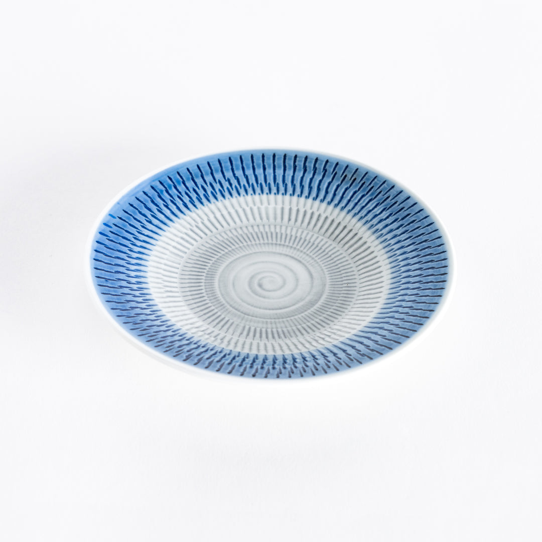 Blue dessert plate with vibrant spiral-striped patterns, viewed from a slight angle.