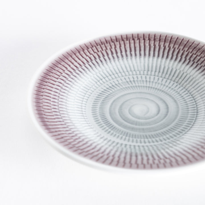 Close-up of the light purple dessert plate, showing the intricate spiral-striped pattern.