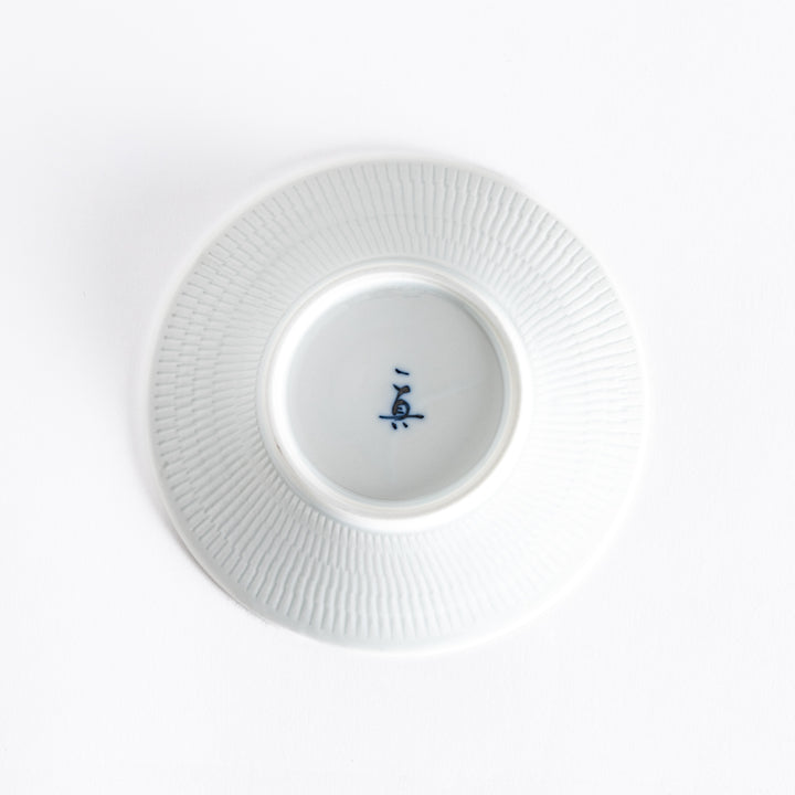 The bottom of the red dessert plate, showcasing its smooth white base and delicate finish.