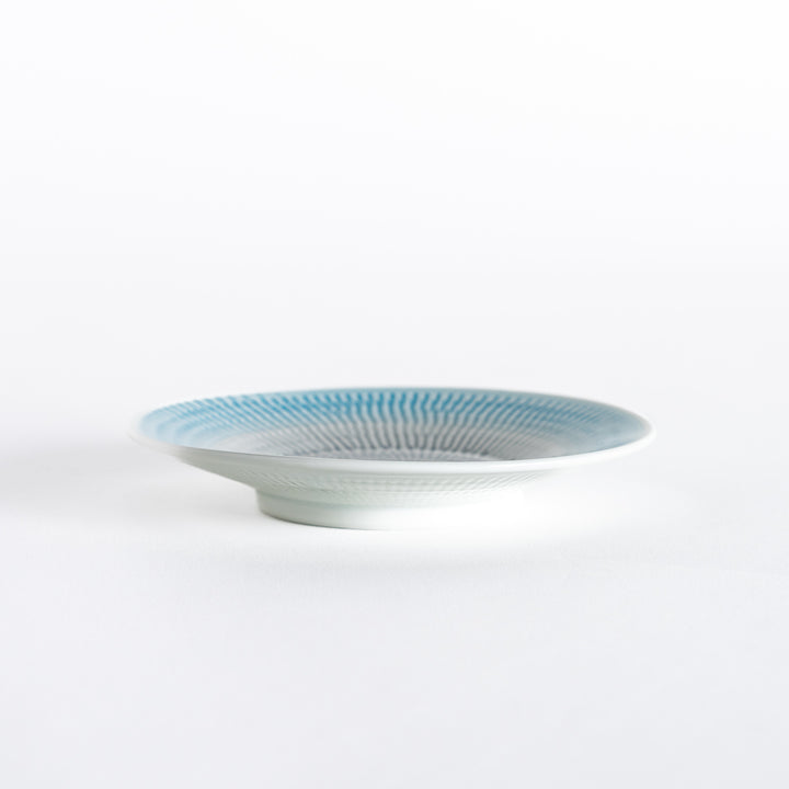 Side view of the light blue dessert plate, highlighting its gentle curvature and clean edges.