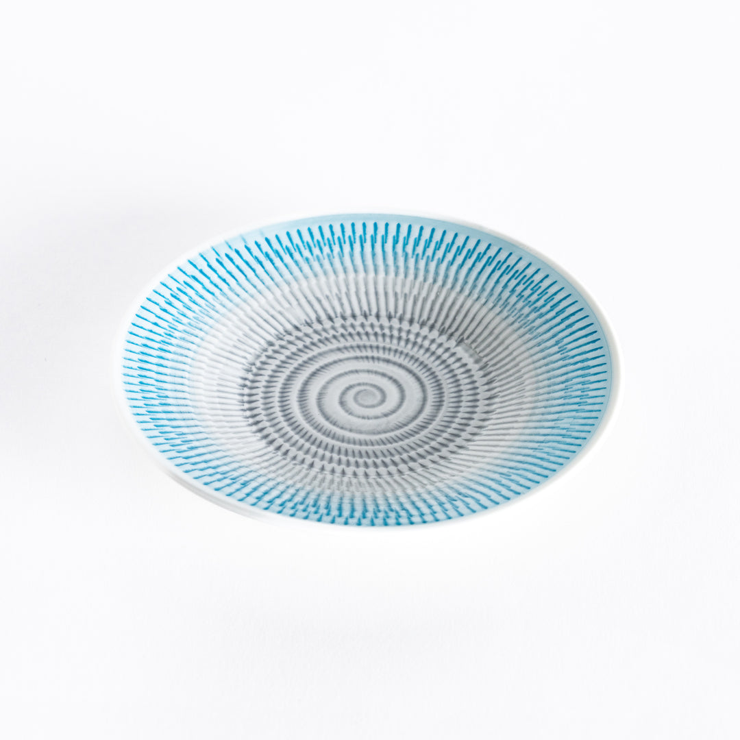 Light blue dessert plate with delicate spiral stripes, photographed at a slight angle.