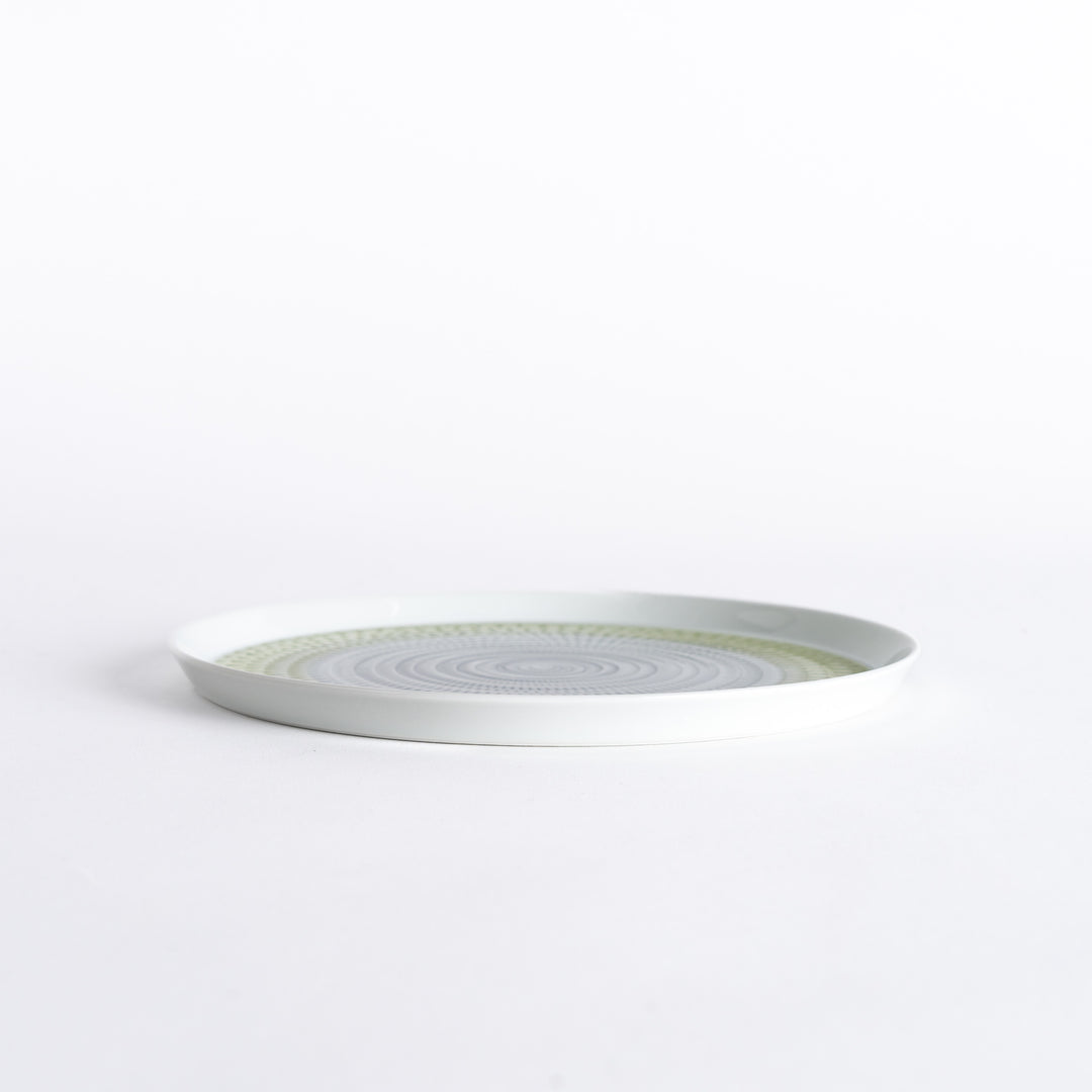 Side view of the plate, showcasing its sleek profile and the vibrant light green spiral design.