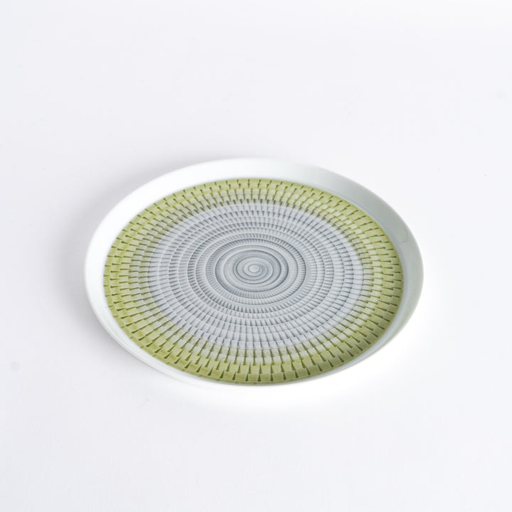 Slightly angled view of the plate, highlighting the light green spiral pattern and subtle curvature.