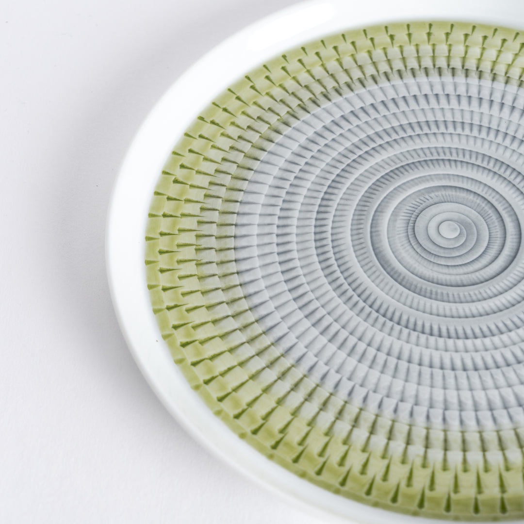 Close-up of the intricate light green spiral pattern, radiating outwards with fine detail.