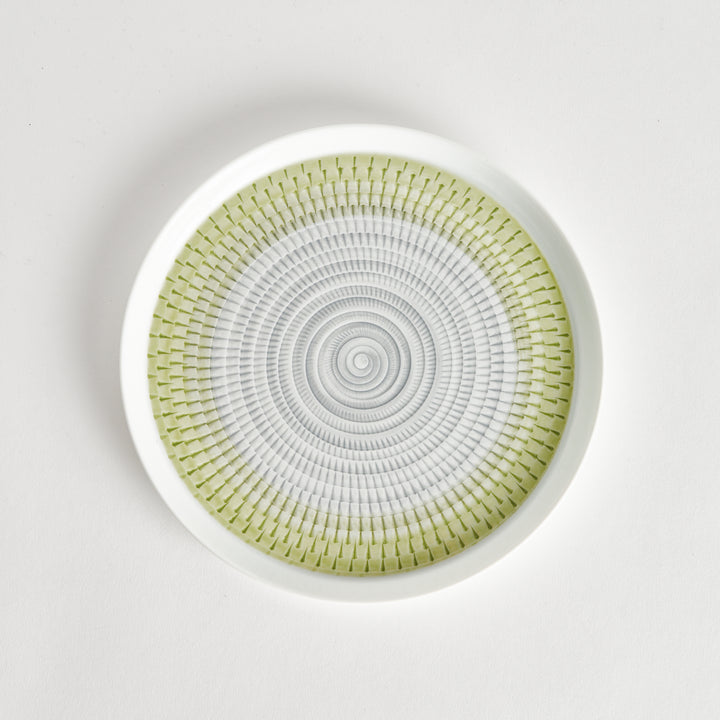 Top view of a plate featuring a light green spiral pattern on a white background.