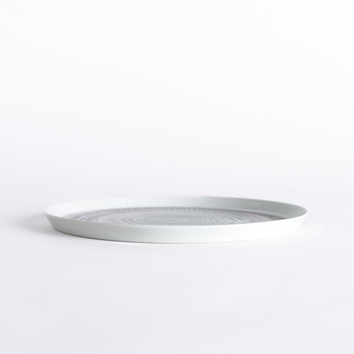 Side view of the plate, showcasing its sleek profile and the vibrant light purple spiral design.