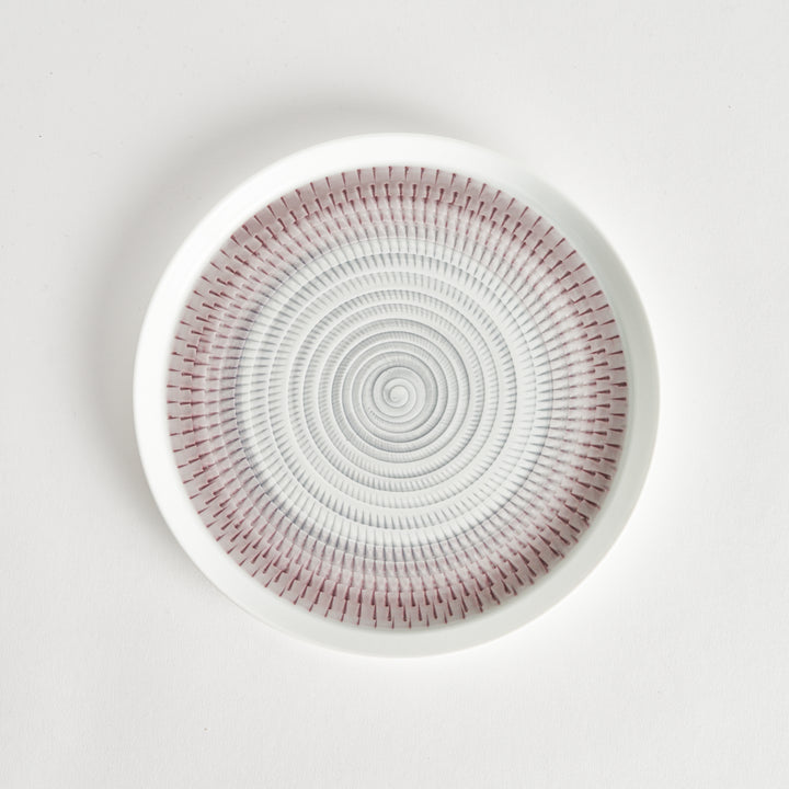 Top view of a plate featuring a light purple spiral pattern on a white background.