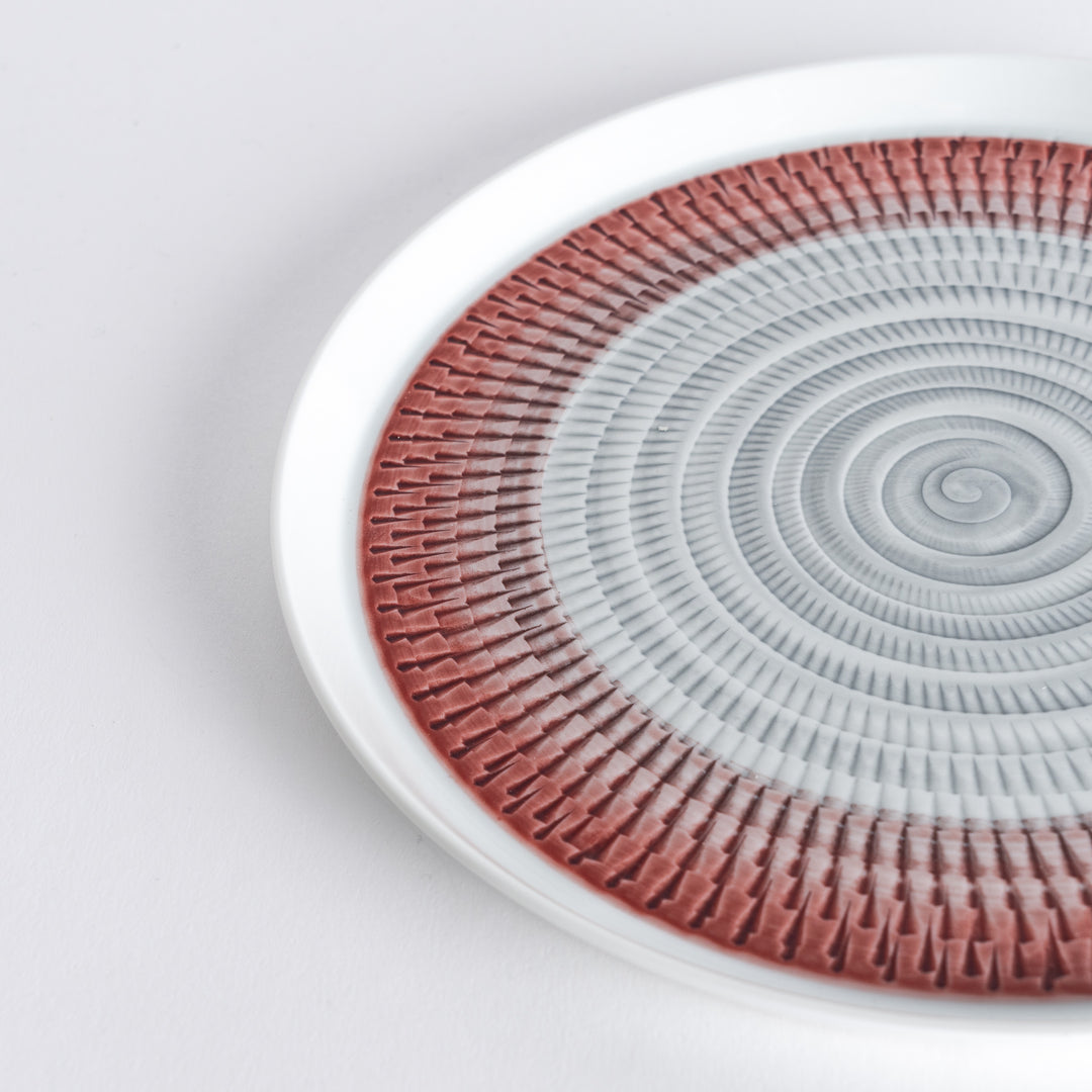 Close-up of the intricate red spiral pattern, radiating outwards with fine detail.