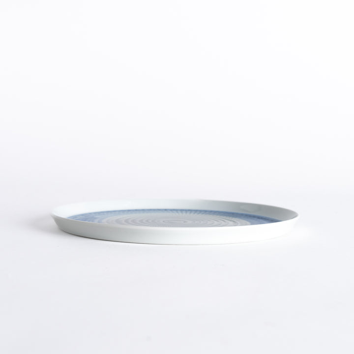 Side view of the plate, showcasing its sleek profile and the vibrant blue spiral design.