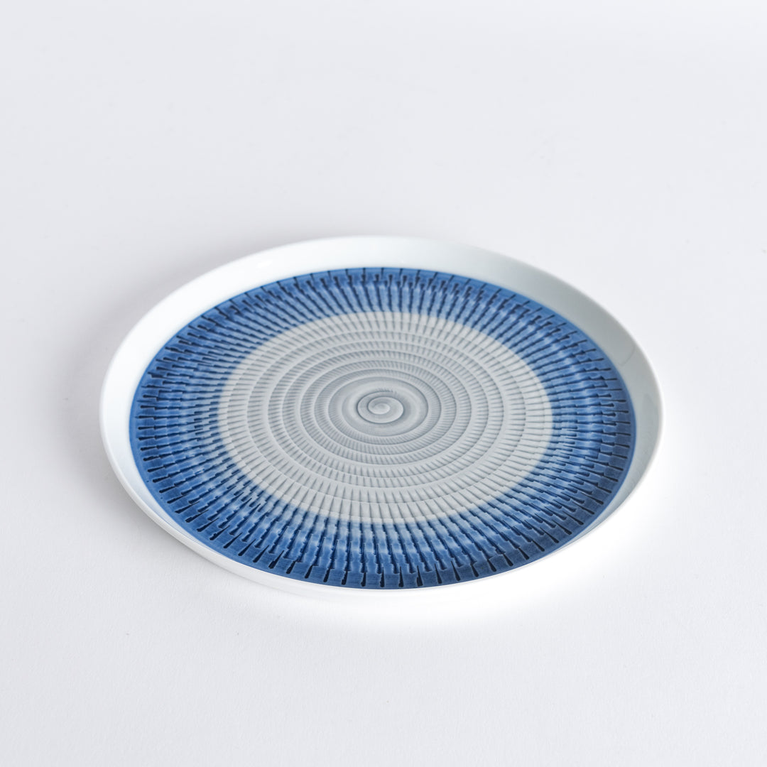 Slightly angled view of the plate, highlighting the blue spiral pattern and subtle curvature.