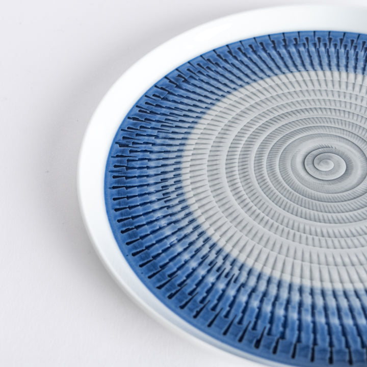 Close-up of the intricate blue spiral pattern, radiating outwards with fine detail.