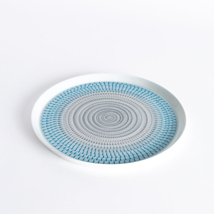 Slightly angled view of the plate, highlighting the light blue spiral pattern and subtle curvature.