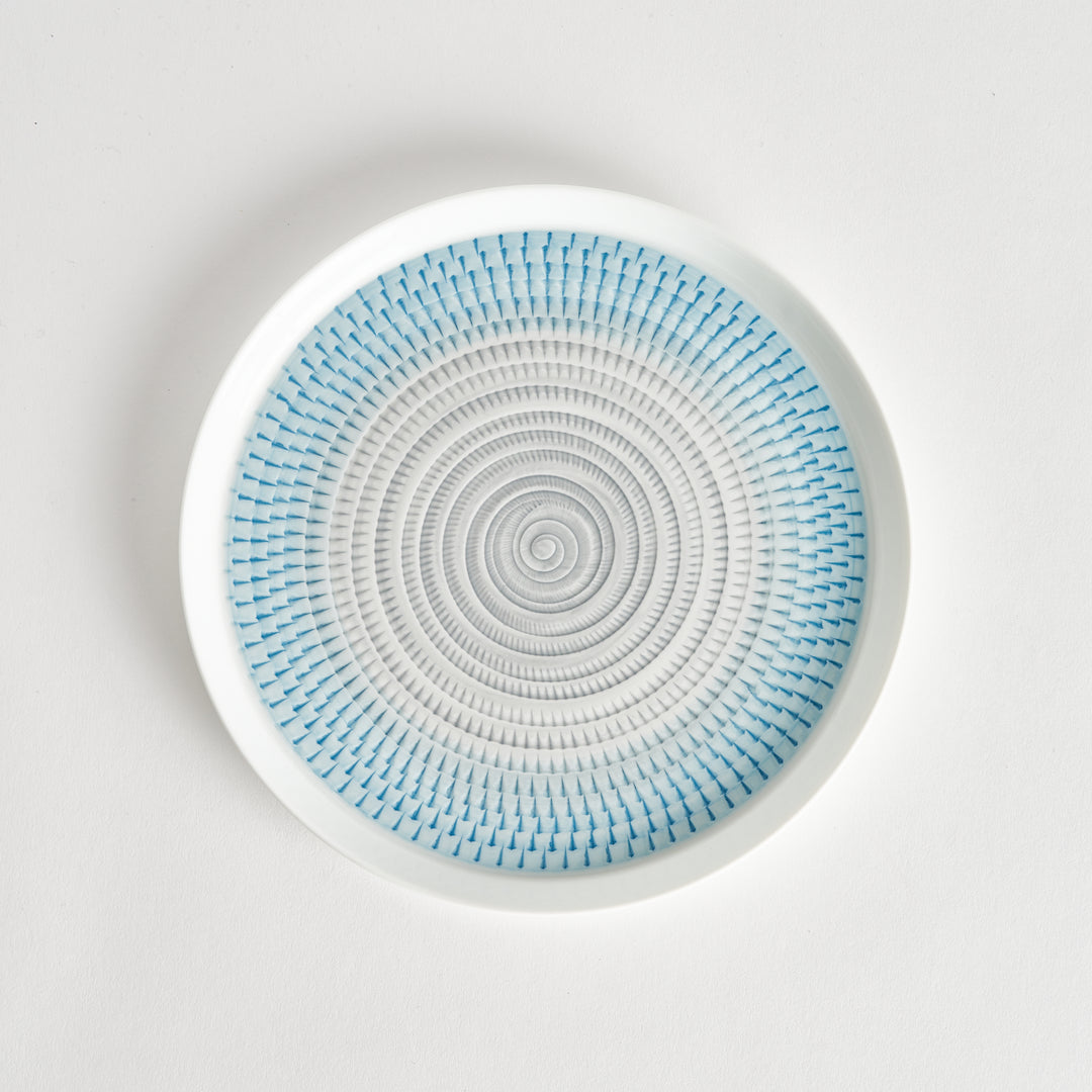 Top view of a plate featuring a light blue spiral pattern on a white background.