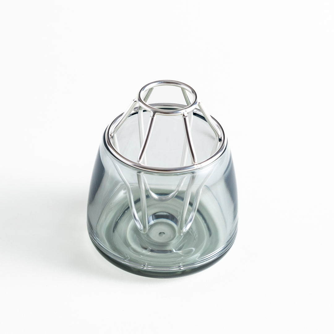 Glass vase with a silver-colored frame on top. The frame has a unique geometric design.