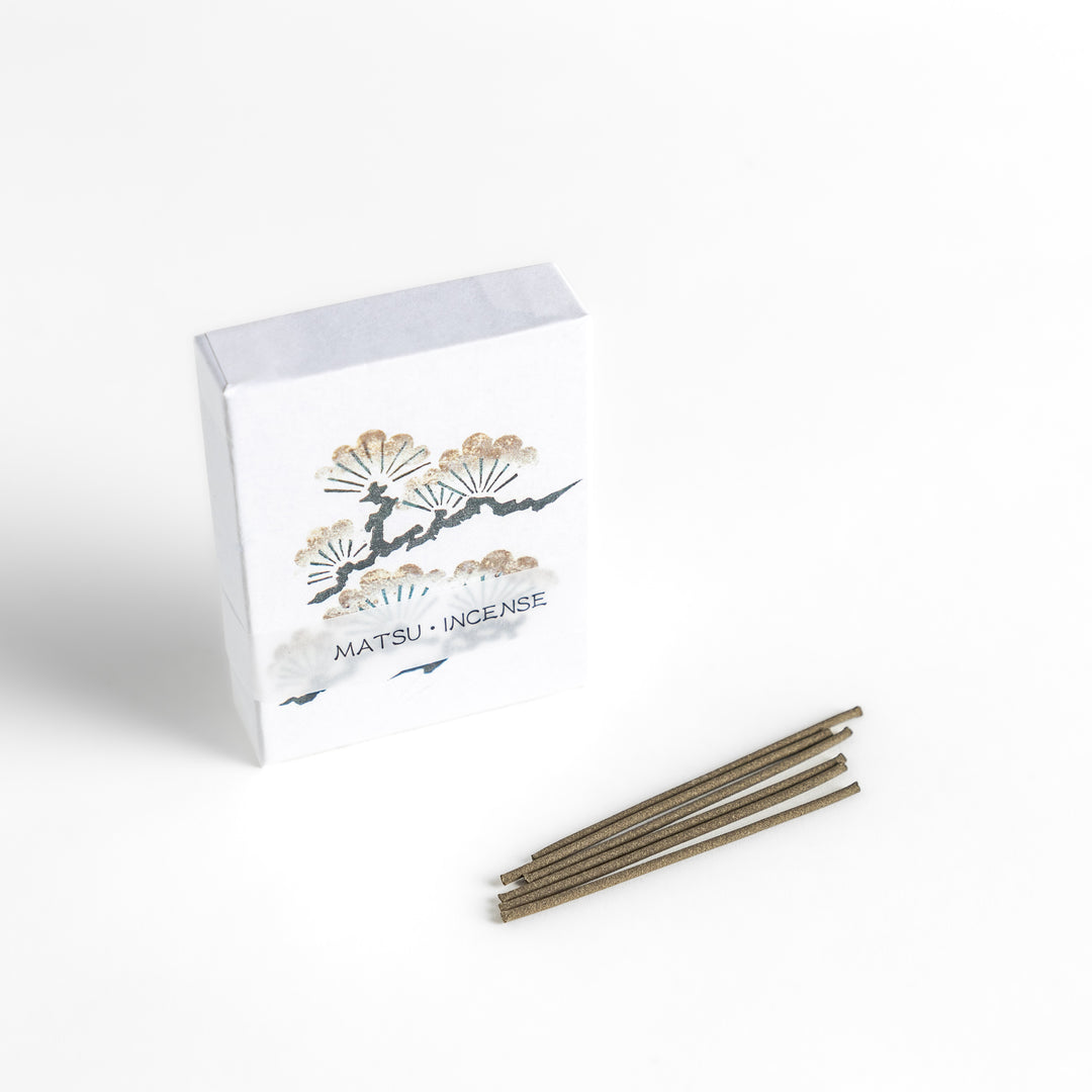 Incense featuring earthy brown sticks in a box adorned with a traditional pine tree design, offering a fresh, woody fragrance reminiscent of evergreen forests.