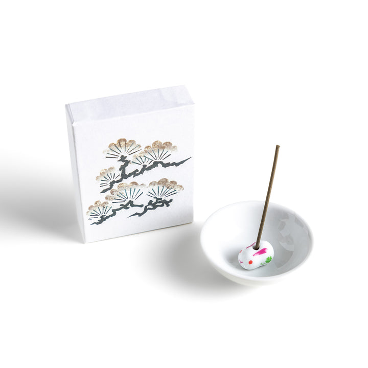 Incense featuring earthy brown sticks in a box adorned with a traditional pine tree design, offering a fresh, woody fragrance reminiscent of evergreen forests.