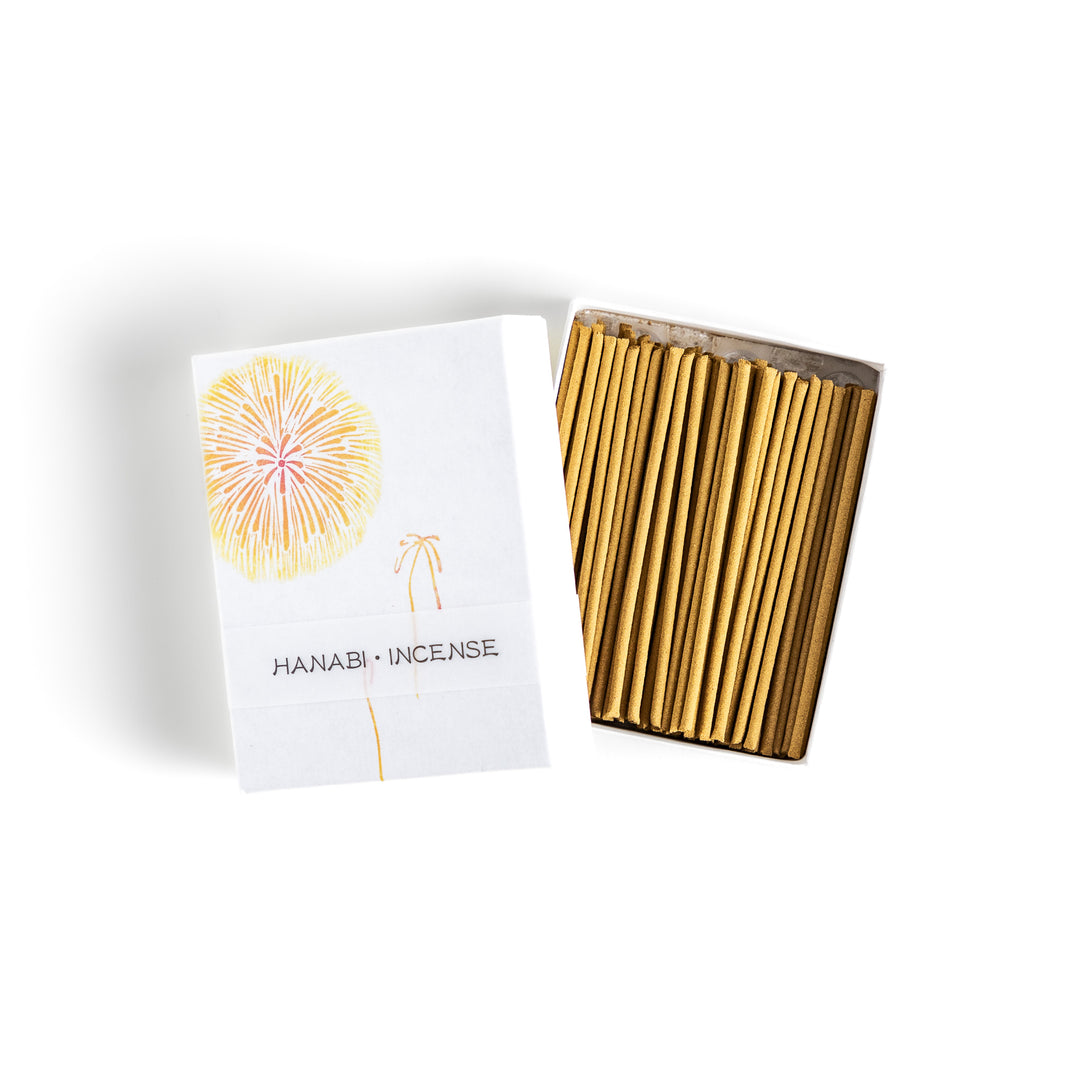 Incense featuring warm golden sticks in a box adorned with a delicate firework design, offering a bright and uplifting fragrance for a festive ambiance.