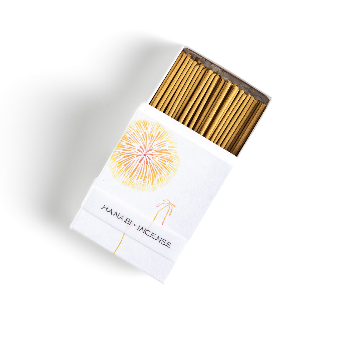 Incense featuring warm golden sticks in a box adorned with a delicate firework design, offering a bright and uplifting fragrance for a festive ambiance.