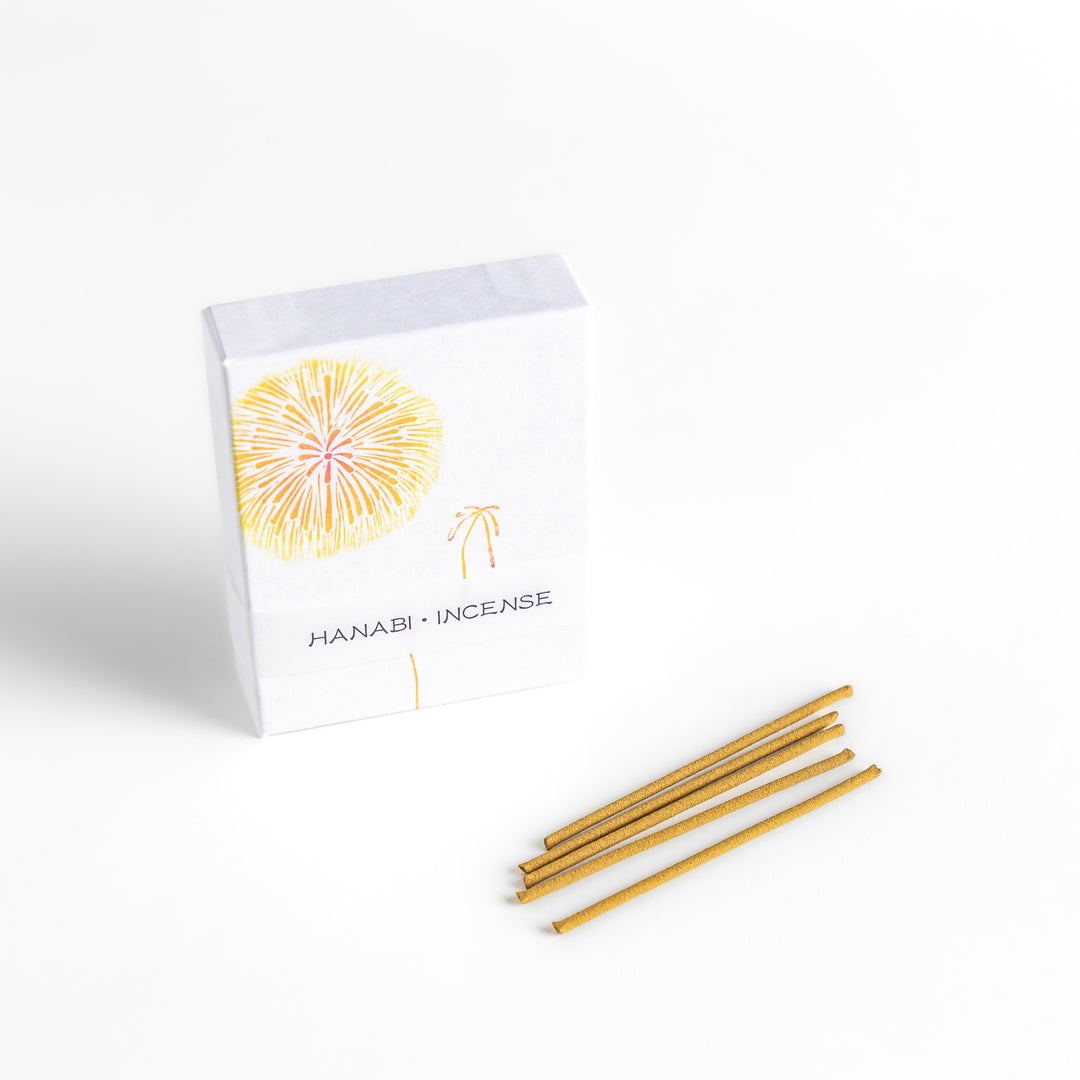 Incense featuring warm golden sticks in a box adorned with a delicate firework design, offering a bright and uplifting fragrance for a festive ambiance.