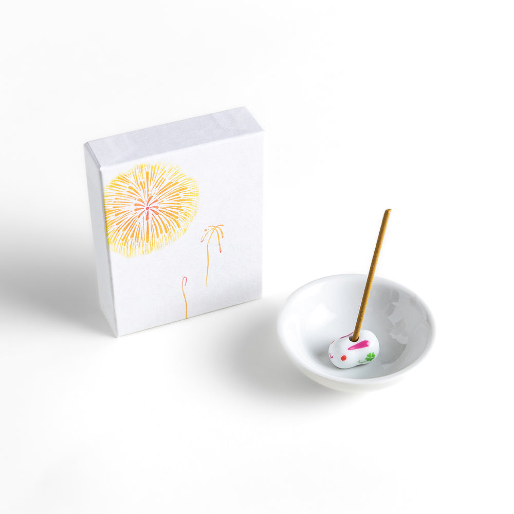 Incense featuring warm golden sticks in a box adorned with a delicate firework design, offering a bright and uplifting fragrance for a festive ambiance.