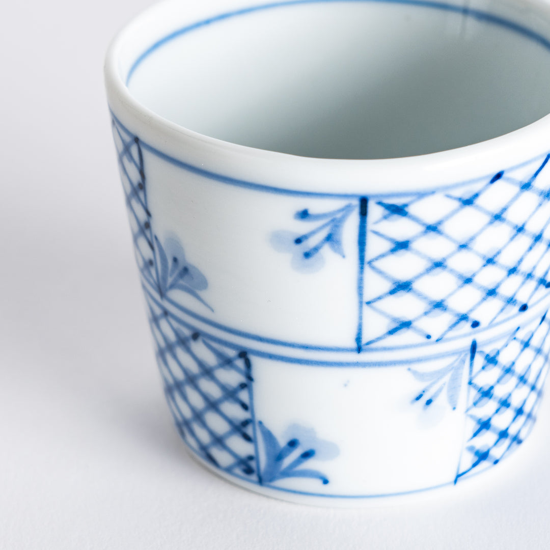 A condiment bowl featuring a geometric pattern of flowers within triangles, available in blue or red ink.