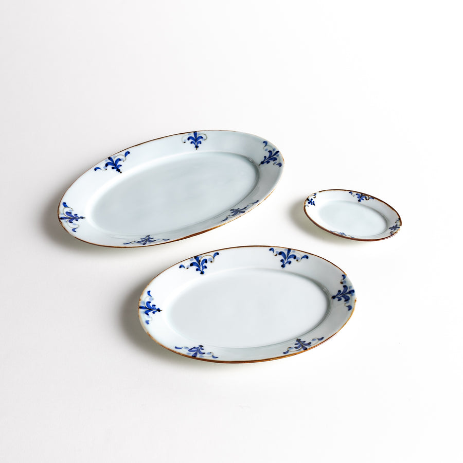 Three oval plates featuring a delicate blue floral leaf pattern around the edges, with a vintage-inspired design.