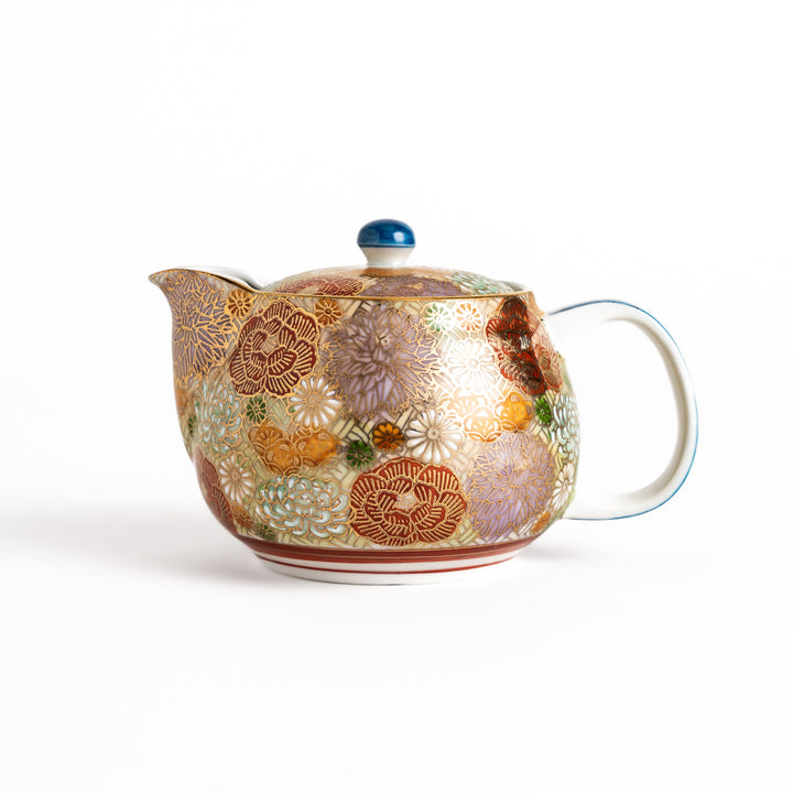 Ceramic teapot with a vibrant floral pattern in gold and pastel colors, featuring a classic design, ideal for brewing and serving tea.