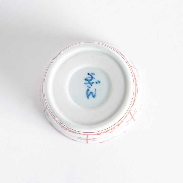 A small white condiment bowl with a delicate blue chrysanthemum and lattice pattern on the exterior.