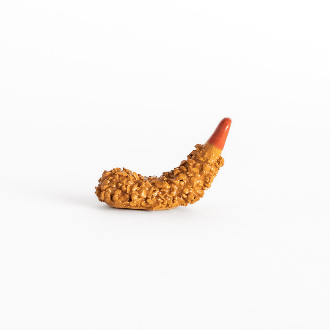 Side view of the fried shrimp chopsticks rest, capturing its dimensional form and lifelike crunchy texture.