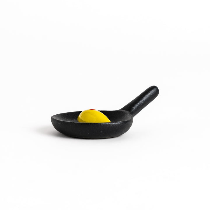 Playful chopstick rest shaped like a miniature frying pan with a Japanese omelette rice, adding a fun and whimsical touch to any meal.