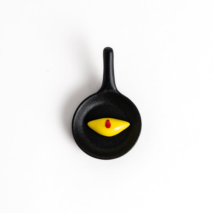 Playful chopstick rest shaped like a miniature frying pan with a Japanese omelette rice, adding a fun and whimsical touch to any meal.