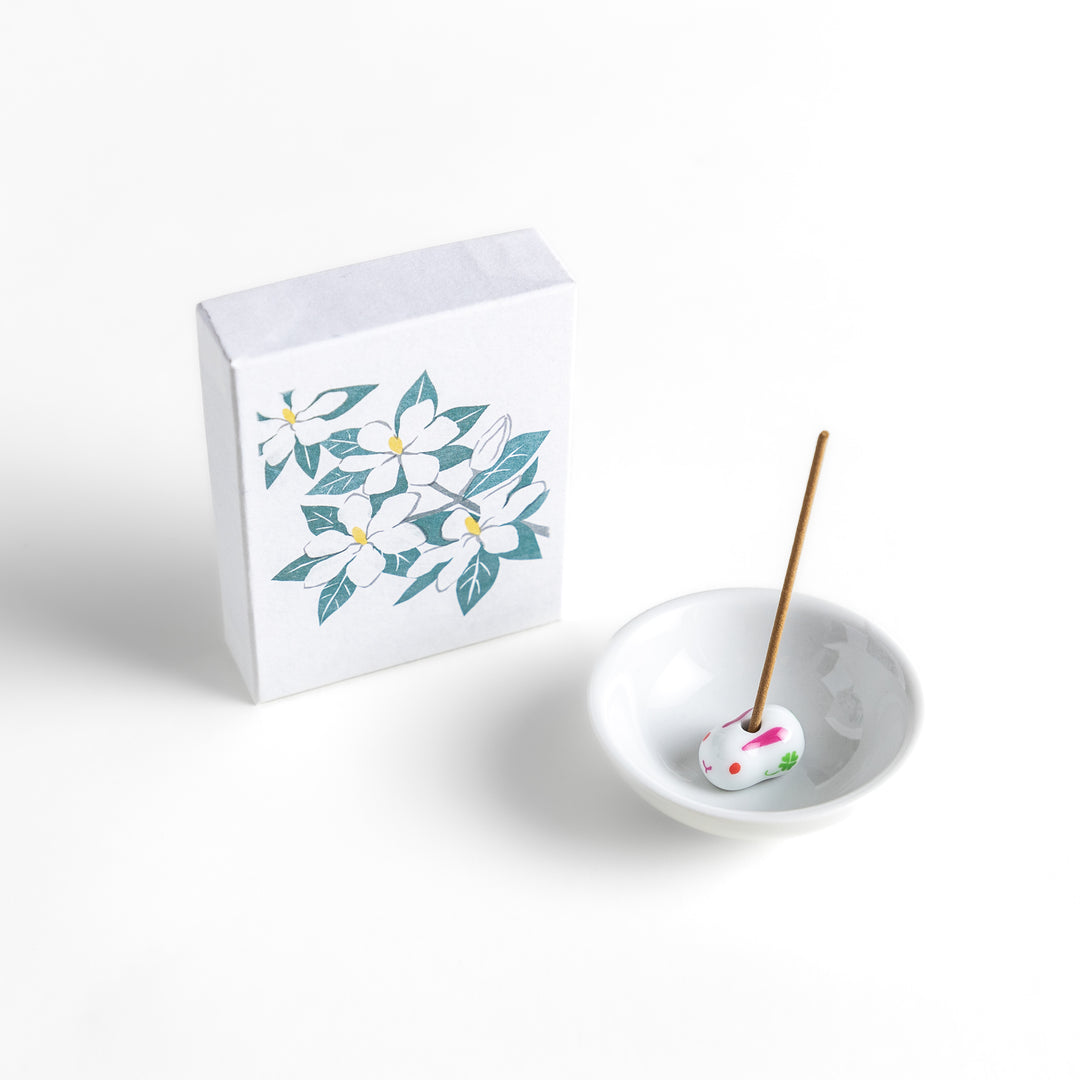 Incense featuring warm beige sticks in a box adorned with an elegant gardenia flower illustration, offering a rich, sweet floral fragrance for a soothing ambiance.