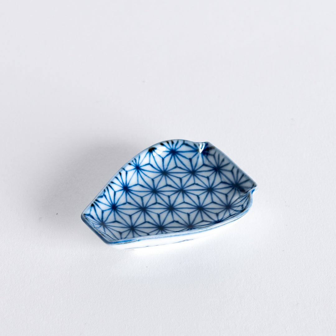 A small, vase-shaped sauce dish featuring a delicate geometric flower pattern in blue, adding a refined touch to your table setting.