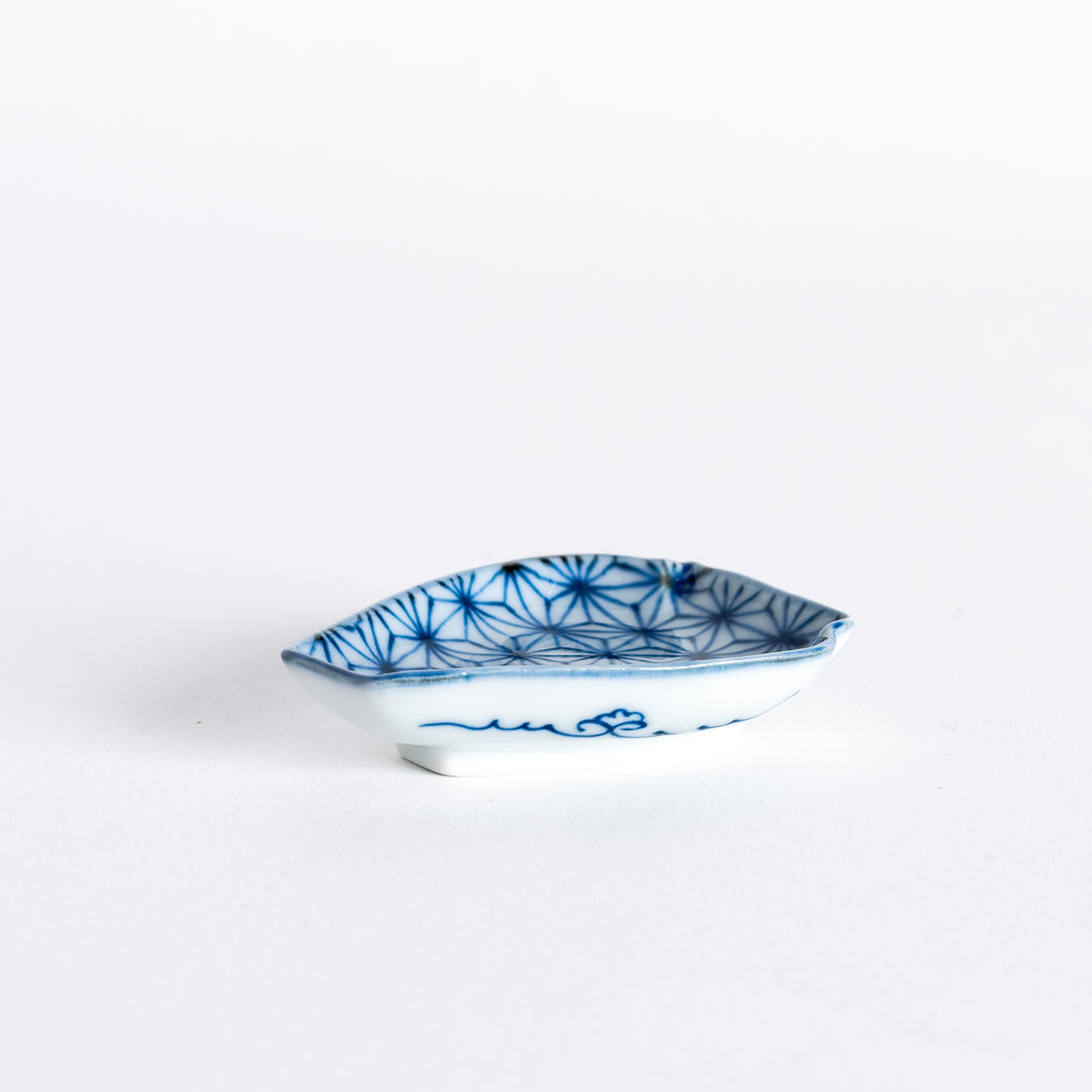 A small,vase-shaped dish with a geometric flower pattern in blue and a delicate wave design at the base, perfect for condiments or small treats.