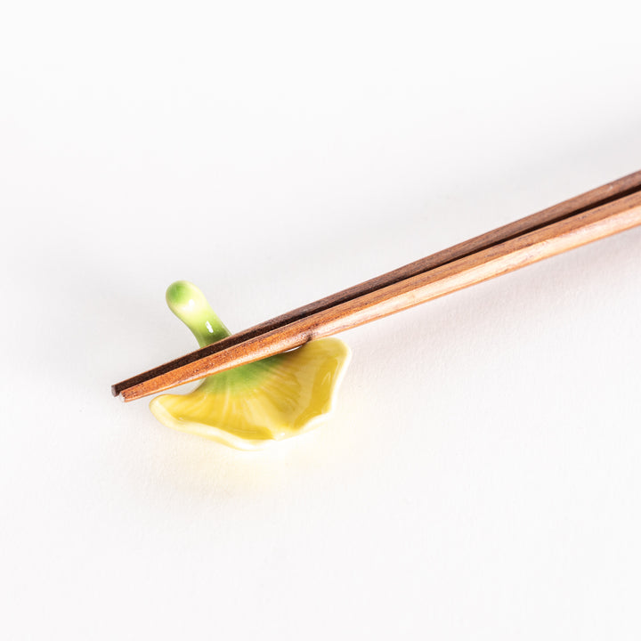 Close-up of the ginkgo chopsticks rest with chopsticks resting across it.