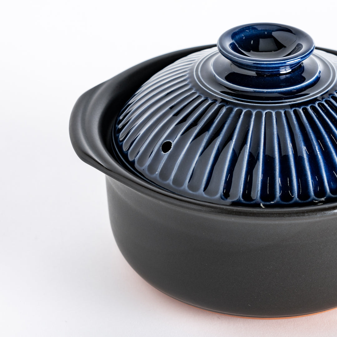 Close-up of the ribbed lid, highlighting its deep navy blue color and glossy texture.