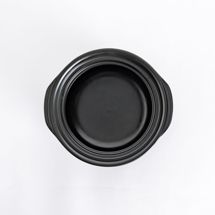 Donabe photographed from above with the lid removed, showcasing the spacious black interior.