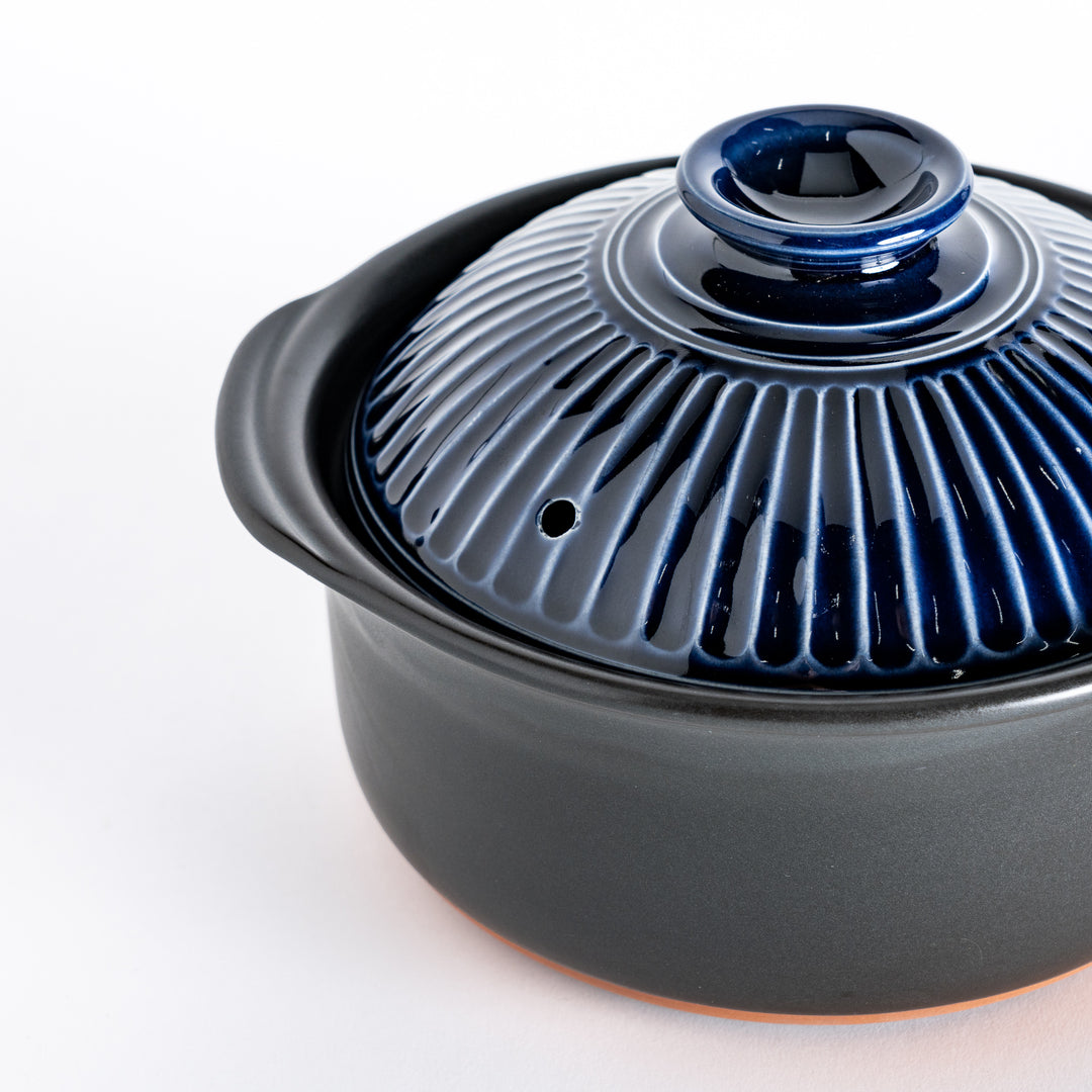 Close-up of the ribbed lid, highlighting its deep navy blue color and glossy texture.