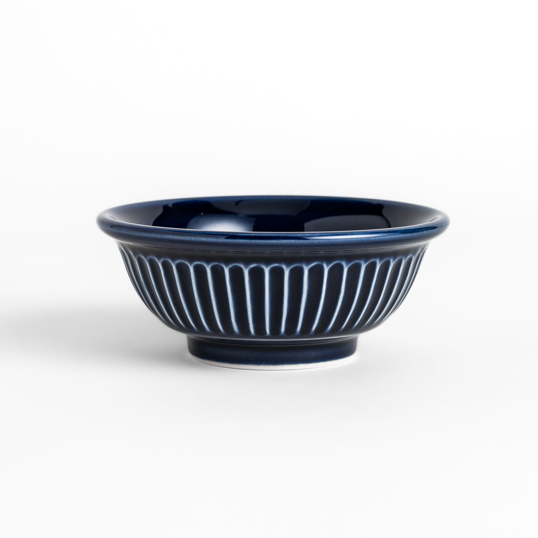 Stylish blue ceramic bowl featuring a unique ridged pattern, ideal for everyday use or special occasions.