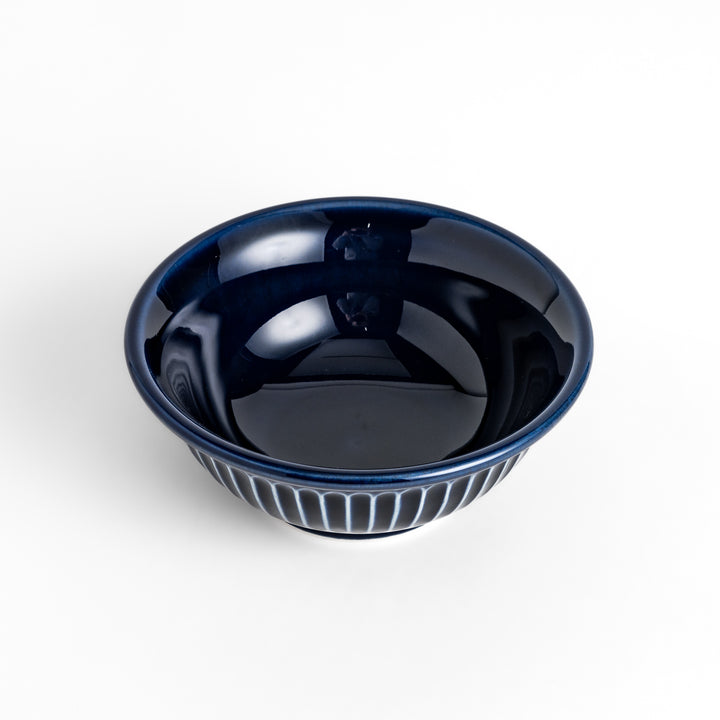 Stylish blue ceramic bowl featuring a unique ridged pattern, ideal for everyday use or special occasions.