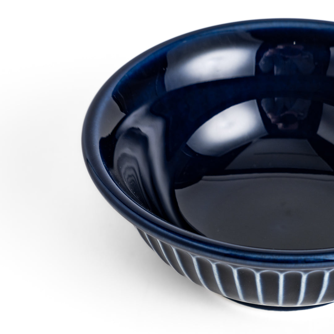 Stylish blue ceramic bowl featuring a unique ridged pattern, ideal for everyday use or special occasions.