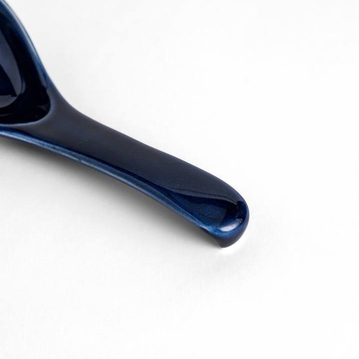 Durable and versatile blue ceramic spoon, perfect for both casual and formal dining.