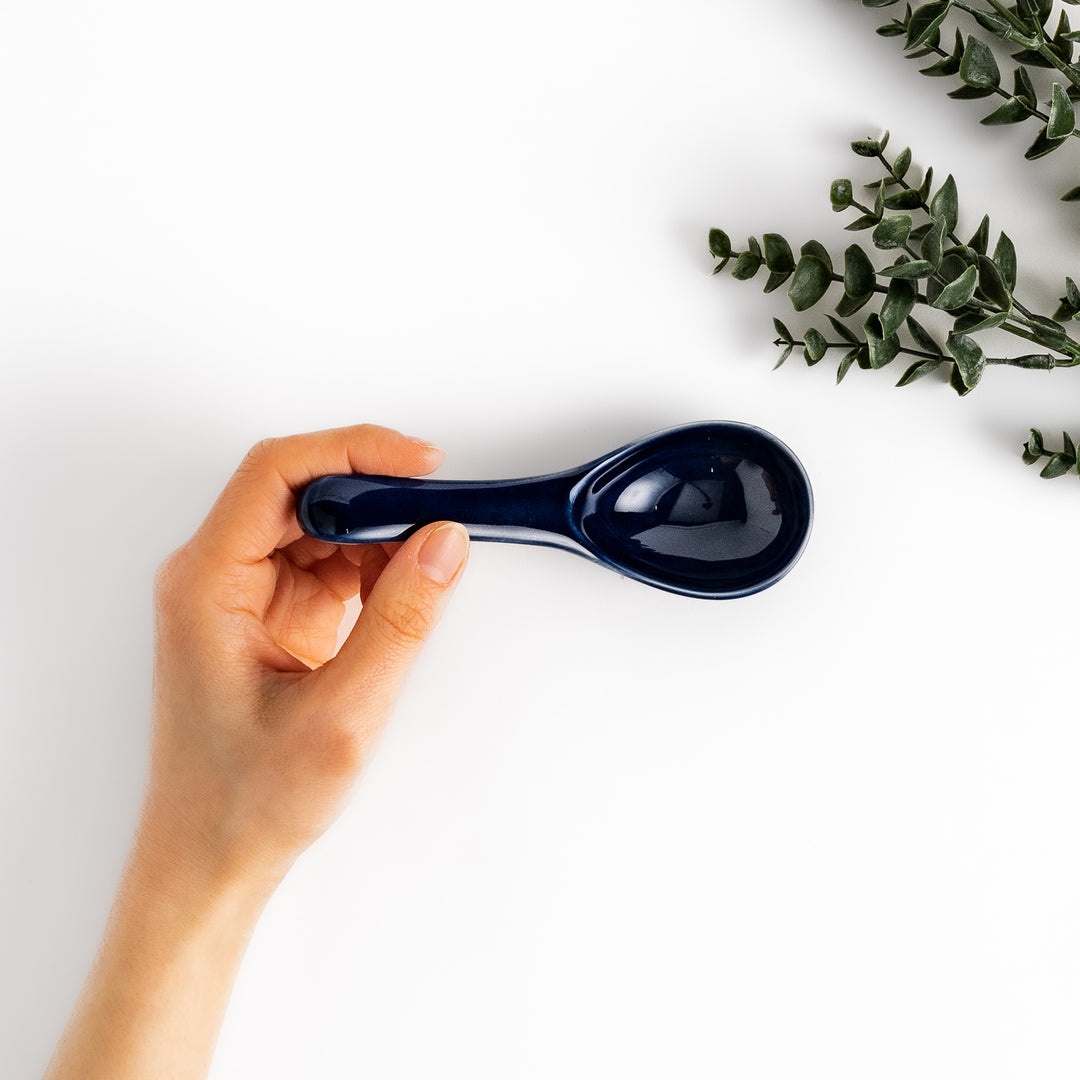 Durable and versatile blue ceramic spoon, perfect for both casual and formal dining.