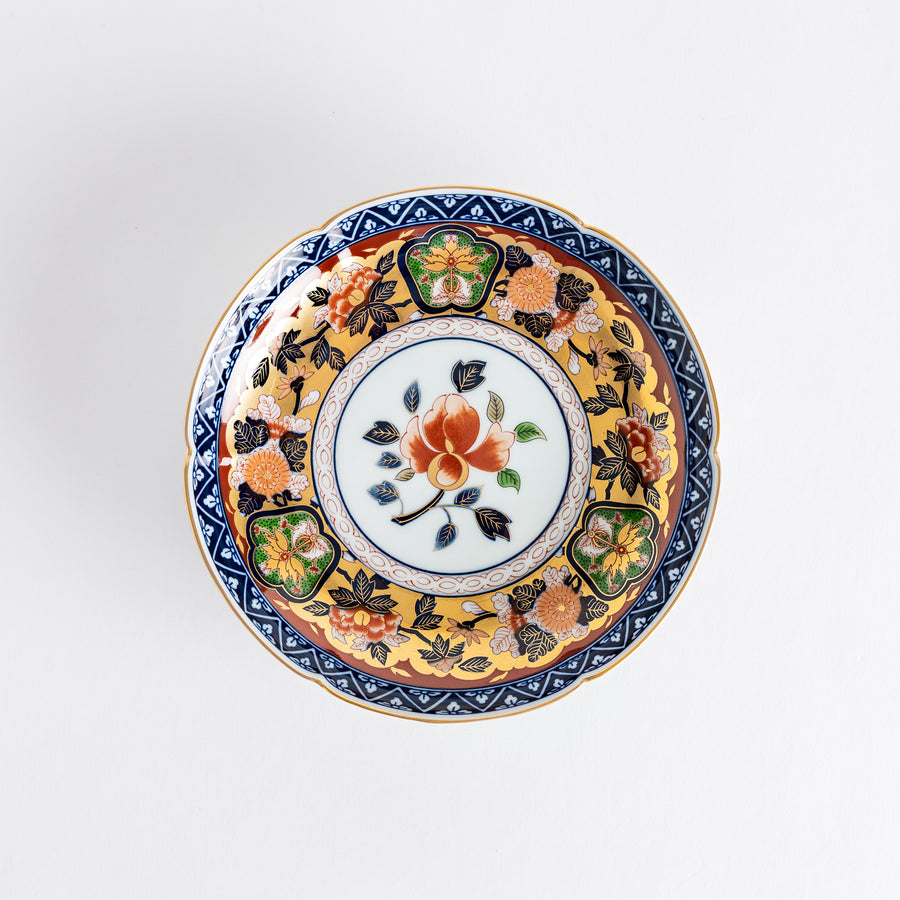 A floral salad plate with intricate gold detailing, showcasing a vibrant red flower at its center surrounded by intricate patterns in green, blue, and gold.