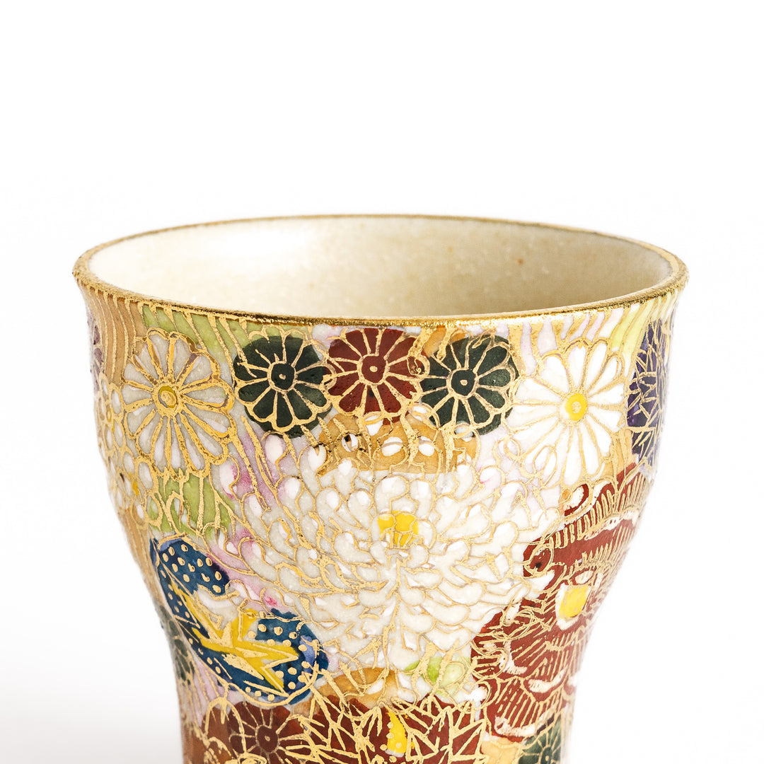 Elegant sake cup with a vibrant floral pattern in gold and pastel colors, perfect for savoring the delicate flavors of sake in style.